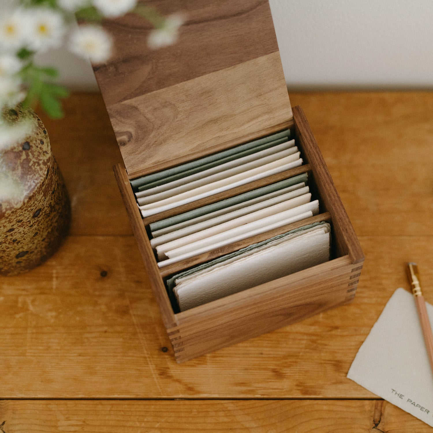 The Paper Way boxed letterpress card collection including assorted notecards, greeting cards, and envelopes on cotton paper.